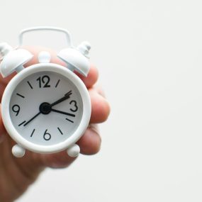 Alarm clock friends situation with hand